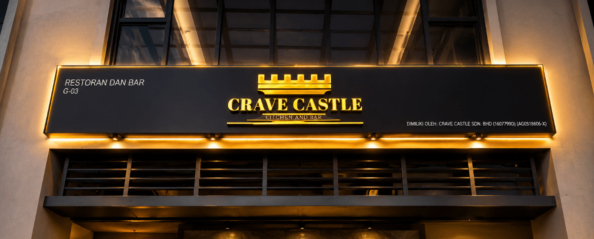 Crave Castle Kitchen & Bar exterior signage illuminated with warm golden lighting, showcasing the restaurant's castle-themed branding and modern facade in Kuala Lumpur.